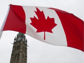 A Canadian flag flies on Parliament Hill Friday February 15, 2013 in Ottawa.