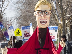 A caricature of Ontario Liberal leader Kathleen Wynne stands out in a group of about 16 OPSEU members who held an "info-picket" in front of MPP John Fraser's office in Ottawa Tuesday January 13, 2015 . (Darren Brown/Ottawa Citizen)