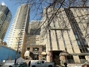 A portion of this building at the corner of Elgin and Lisgar in downtown Ottawa, at 169 Lisgar Street (right), is converting its top five floors from commercial space into residential rental units. The refurbishment will involve the upper floors on the left side of the dark mirrored glass. The lower floors will remain part of an indoor parking garage.