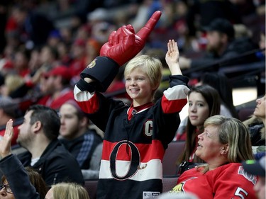 A young Ottawa fan begins to celebrate in the third period.