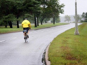 A lone biker travels along the West bound Ottawa River Parkway. A study recommends closing the west-bound lanes in order to transform them into a bicycle-only linear park.