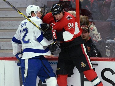 Ottawa Senators' Alex Chiasson hits Tampa Bay Lightning's Andrej Sustr during second period NHL hockey action in Ottawa on Sunday, Jan 4, 2015.