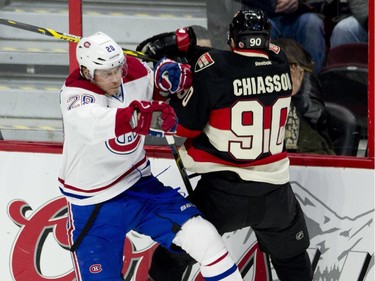 Montreal Canadiens defenceman Nathan Beaulieu collides with Ottawa Senators right wing Alex Chiasson along the boards during first periond NHL action.