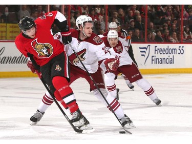 Bobby Ryan #6 of the Ottawa Senators controls the puck as he is tied up by Oliver Ekman-Larsson #23 of the Arizona Coyotes at Canadian Tire Centre on January 31, 2015 in Ottawa, Ontario, Canada.