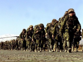 Heavily laden with their full kit, members of the 3rd Battalion, Princess Patrica's Canadian Light Infantry (3 PPCLI) Battle Group march to the Chinook helicopters waiting to transport them into the mountains near Gardez in eastern Afghanistan in 2002.