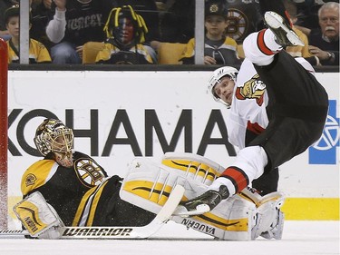 Ottawa Senators' Bobby Ryan, right, trips over Boston Bruins gaolie Tuukka Rask, of Finland, after scoring the winning goal during overtime in an NHL hockey game in Boston, Saturday, Jan. 3, 2015. The Senators won 3-2.