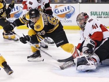 Ottawa Senators goalie Craig Anderson (41) blocks a shot by Boston Bruins' Brad Marchand (63) during the second period of an NHL hockey game in Boston, Saturday, Jan. 3, 2015.