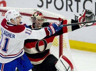 Montreal Canadiens right wing Brendan Gallagher swings at the puck as Ottawa Senators goalie Craig Anderson reaches with his glove during first periond NHL action.