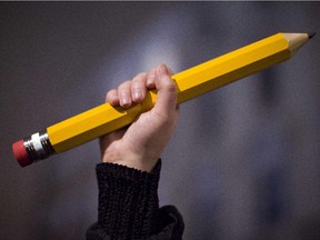 A giant pencil is held up at a vigil outside The French Institute in London on January 9, 2015 for the 12 victims of the attack on the Paris offices of satirical weekly Charlie Hebdo.