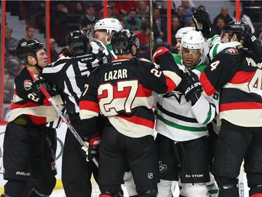 Chris Neil, left, of the Ottawa Senators tries to create emotion on the ice for his team against the Dallas Stars during first period NHL action.
