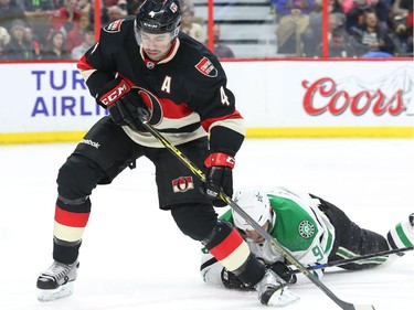 Chris Phillips of the Ottawa Senators strips the puck from Tyler Seguin of the Dallas Stars during second period NHL action.