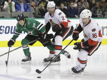 Ottawa Senators left wing Clarke MacArthur (16) skates with the puck as teammate defenceman Jared Cowen (2) ties up Dallas Stars centre Cody Eakin (20) during the first period.