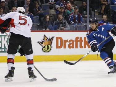 Colorado Avalanche right wing Jarome Iginla, right, uncorks a one-time shot for a goal past Ottawa Senators defenseman Cody Ceci during the first period of an NHL hockey game Thursday, Jan. 8, 2015, in Denver.