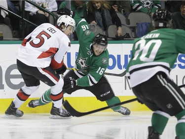 Ottawa Senators defenceman Cody Ceci (5) and Dallas Stars left wing Ryan Garbutt (16) turn to head for the puck as Stars Cody Eakin (20) skates in during the first period.