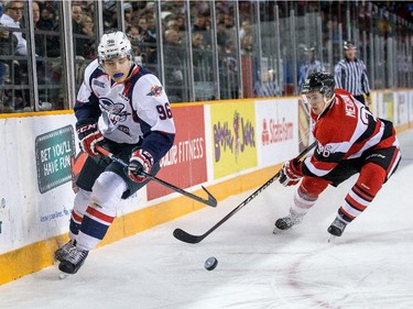 Cristiano DiGiancinto, left, is pursued by an Ottawa 67's player in the first period.