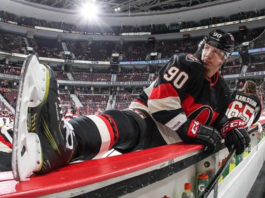 Stretching along the boards during warmup, Alex Chiasson #90 of the Ottawa Senators looks down the ice prior game against his former team.