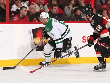 Trevor Daley #6 of the Dallas Stars stickhandles the puck against Mike Hoffman #68 of the Ottawa Senators.