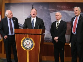 Senate Assistant Minority Leader Dick Durbin, (D-IL)(2ndL) speaks while flanked by House Ways and Means ranking member U.S. Rep. Sander Levin, (D-MI) (L),  Senate Armed Services ranking member U.S. Sen. Jack Reed, (D-RI) (2ndR) and U.S. Rep. Lloyd Doggett, (D-TX  (R)during a news conference on Capitol Hill, January 20, 2015 in Washington, DC. The Democratic lawmakers announced legislation to tighten restrictions on corporate tax inversions, making it more difficult for American companies to lower their U.S. taxation by combining with a smaller foreign business and moving their tax address overseas.