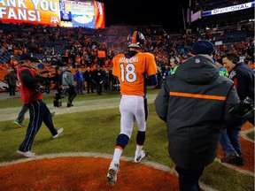 Peyton Manning #18 of the Denver Broncos walks off the field after losing 24-13 to the Indianapolis Colts in a 2015 AFC Divisional Playoff game at Sports Authority Field at Mile High on January 11, 2015 in Denver, Colorado.
