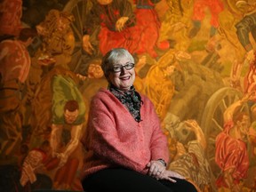 Dr. Laura Brandon, the resident Historian of Art and War at the Canadian War Museum, is retiring after 22 years. Here, she sits in front of one of her favourite paintings, The First German Gas Attack at Ypres by William Roberts (1918), at the museum.