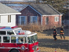 Firefighters attend the scene where a large quantity of unidentified chemicals were found in a residence in Grand Desert, N.S. on Wednesday, Jan. 21, 2015. The RCMP brought Christopher Burton Phillips brought back to Nova Scotia from Ottawa on Thursday after he was arrested a day earlier at a hotel that had to be evacuated.