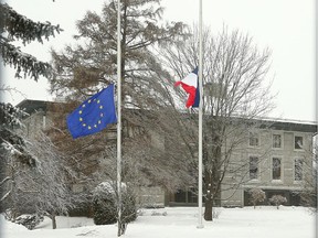Flags fly at half mast on the lawn of the French Embassy in Ottawa following the terrorist attack at a magazine office in France, which left 12 people dead. (Julie Oliver / Ottawa Citizen)