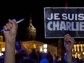 A person holds a placard reading, "I am Charlie" in Clermont-Ferrand, on January 7, 2015, during a rally in support of the victims of the attack by unknown gunmen on the offices of the satirical weekly, Charlie Hebdo. Heavily armed gunmen massacred 12 people on Wednesday after bursting into the Paris offices of a satirical weekly that had long outraged Muslims with controversial cartoons of the prophet Mohammed.