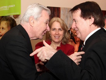 From left, patron Bill Teron enjoys an animated conversation with board member James Wright at the post-concert reception for pianist Angela Hewitt's performance at Dominion-Chalmers church on Wednesday, January 14, 2015, as part of the Chamberfest winter concert series.
