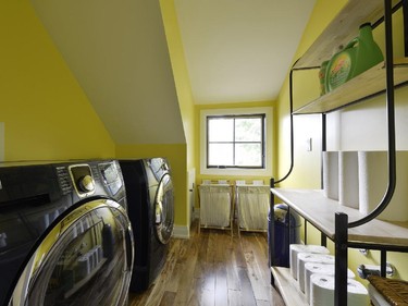 The original home’s only bathroom is now a laundry room in sunny yellow.