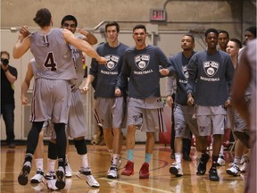 Gabriel Gonthier-Dubue #4 and Vikas Gill #1 of the Ottawa Gee-Gees celebrate their 68-66 win against the Carleton Ravens at Montpetit Hall on Jan. 10, 2015.