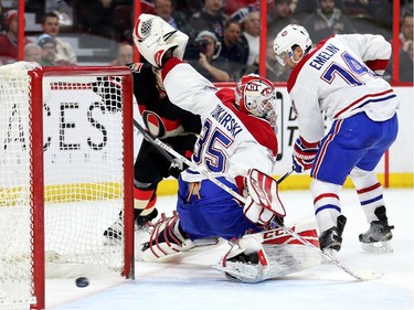 Goalie Dustin Tokarski looks back as Jean-Gabriel Pageau (not shown) scores his first goal of the season in the first period.