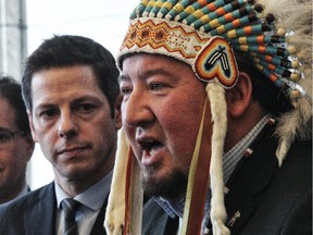 Grand Chief Derek Nepinak addresses the media regarding racism in Winnipeg while Mayor Brian Bowman listens in background.