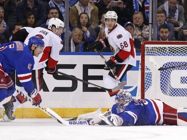 Ottawa Senators left wing Mike Hoffman (68) watches from behind the net as New York Rangers goalie Henrik Lundqvist (30) eyes the puck in front of him after falling to the ice to make a save during the second period.