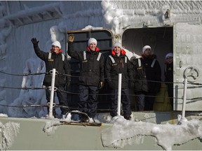 Sailors wave from an ice-encrusted deck on HMCS Toronto as they return to port in Halifax on Sunday, Jan. 18, 2015. The frigate was on a six-month deployment with Operation Reassurance in the Mediterranean Sea.