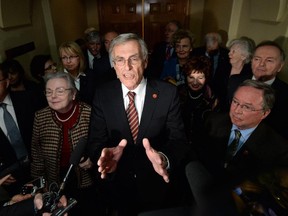James Cowan, flanked by other newly declared Independent Senators, speaks to reporters on Parliament Hill in Ottawa on Wed., January 29, 2014, following Liberal leader Justin Trudeau's announcement to remove senators from the caucus.