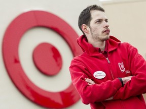 James Pelletier, poses under the Target logo at Hazeldean Mall in Ottawa Saturday January 24, 2015. Pelletier worries his autism will make it very difficult to find work after the retail giant closes its doors for good.