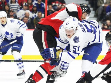 Jared Cowen of the Ottawa Senators hits Jake Gardiner of the Toronto Maple Leafs during second period NHL action.