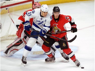 Ottawa Senators' Jean-Gabriel Pageau, right, defends against Tampa Bay Lightning's Brian Boyle during second period NHL hockey action in Ottawa on Sunday, Jan 4, 2015.