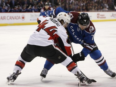 Ottawa Senators center Jean-Gabriel Pageau, front, battles for control of the puck off the face-off with Colorado Avalanche center John Mitchell during the first period of an NHL hockey game Thursday, Jan. 8, 2015, in Denver.