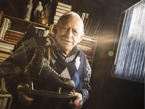 Jean-Marie Leduc, 78, poses with a skates worn by Montreal Canadiens' and NHL Hall of Fame player, Emile "Butch" Bouchard, in his Ottawa home Tuesday January 13, 2015. Leduc has around 350 pairs of skates including a pair of bison bone skates dating back 15,000 years. (Darren Brown/Ottawa Citizen)