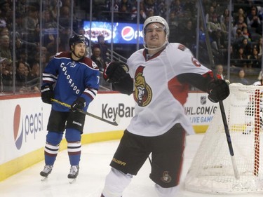 Ottawa Senators right wing Mark Stone, front, celebrates his goal as Colorado Avalanche center John Mitchell skates at left during the second period of an NHL hockey game Thursday, Jan. 8, 2015, in Denver.