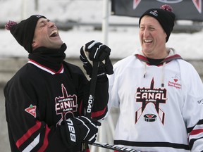 Joël-Denis Bellavance of La Press (left) and MP Peter MacKay (right) share a laugh during the second annual Canadian Tire Canal Classic in support of Jumpstart, in Ottawa, January 29, 2015.