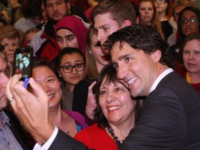 Liberal Leader Justin Trudeau takes a selfie with supporters at a Liberal Party rally in London, Ont. Tuesday night.