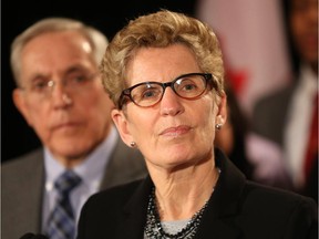 Ontario Premier Kathleen Wynne speaks Friday at the Chateau Laurier in Ottawa as MPP Bob Chiarelli looks on.