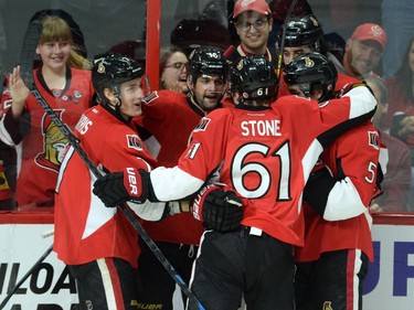 Ottawa Senators' Kyle Turris, left, celebrates his first period goal with teammates while taking on Tampa Bay Lightning in first period NHL hockey action in Ottawa on Sunday, Jan 4, 2015.
