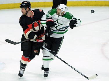 Ottawa Senators' Marc Methot, left, and Dallas Stars' Patrick Eaves brace for the incoming shot during second period NHL hockey action.