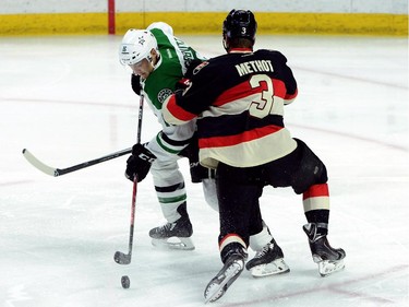Ottawa Senators' Marc Methot tries to push Dallas Stars' Ryan Garbutt off the puck during first period NHL hockey action.