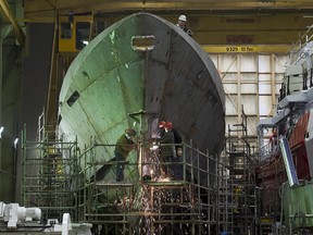 Technicians work on a hull at Halifax Shipyard in Halifax on Thursday, March 7, 2013. Ottawa has signed a $288 million contract for the design of new Arctic offshore patrol ships as part of its shipbuilding procurement project. The Irving-owned shipyard was awarded a large share of a 35-billion-dollar federal procurement project last year. THE CANADIAN PRESS/Andrew Vaughan
