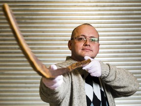 Mark Presley poses with the oldest known ice hockey stick in the world, hand hewn in the 1830s in Cape Breton, Nova Scotia from a single piece of sugar maple, at the Canadian Museum of History  Friday January 09, 2015 . Presley sold the stick to the museum for $300,000 after originally purchasing the stick for $1,000.