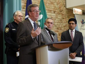 Mayor Jim Watson speaks during a press conference after meeting with Ottawa Police Chief Charles Bordeleau, Ottawa Centre MPP Yasir Naqvi, Coun. Eli El-Chantiry, who chairs the police services board, and Ken Bryden, Acting Staff Sergeant of the Ottawa Police Guns and Gang Unit, on Monday evening, Jan. 12, 2015. The meeting was held to address the spike in gang-related shootings in Ottawa.